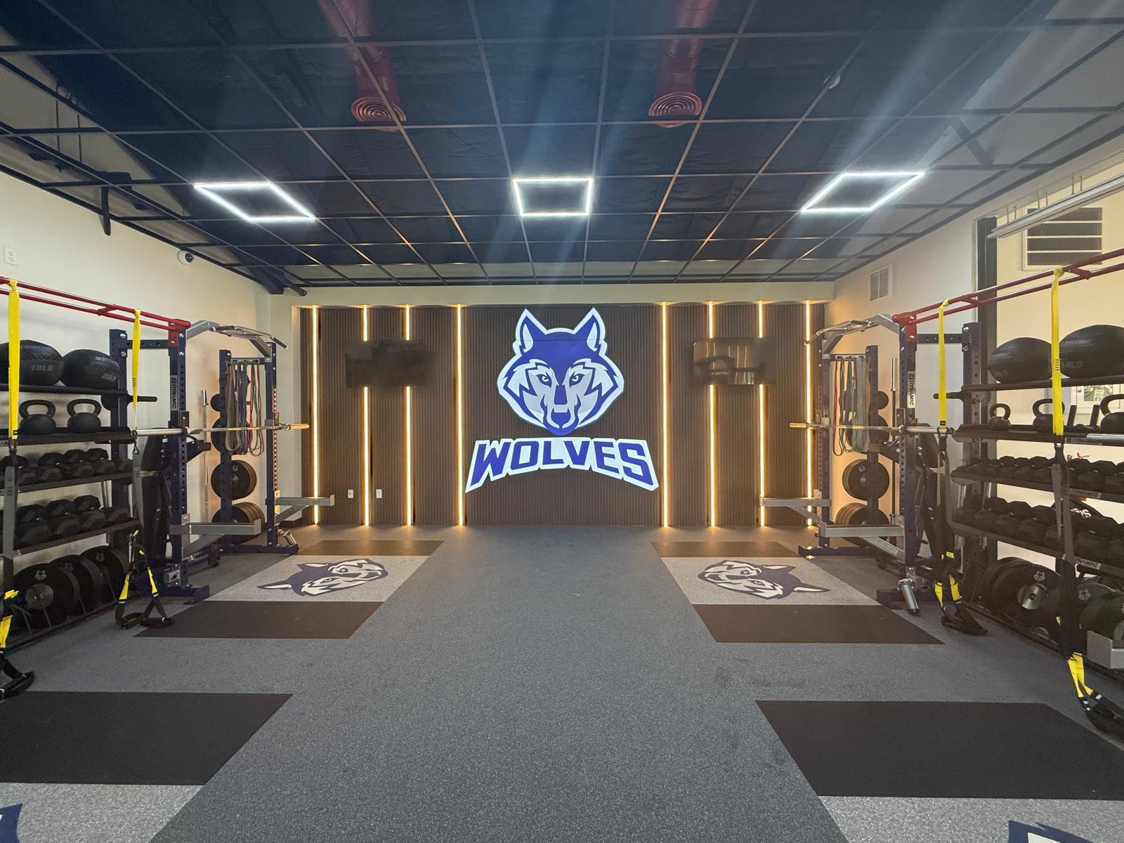 The aisle between the racks, ending at the lit Wolves wall
