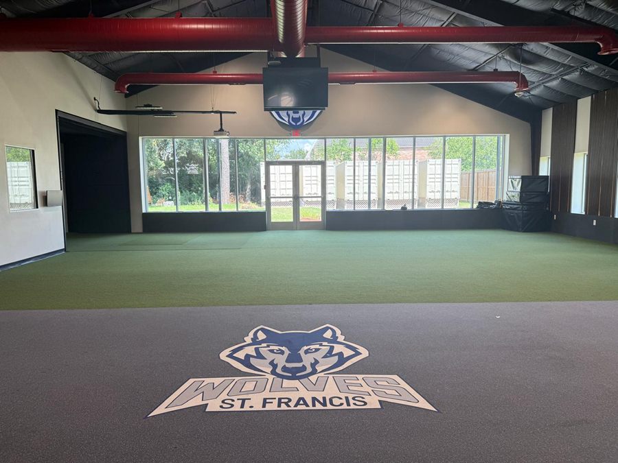 From the weight room floor, past the inlaid Wolves St. Francis logo, across the turf to the glazed end wall and double doors